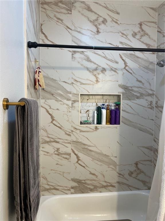 bathroom with shower / bath combo with shower curtain