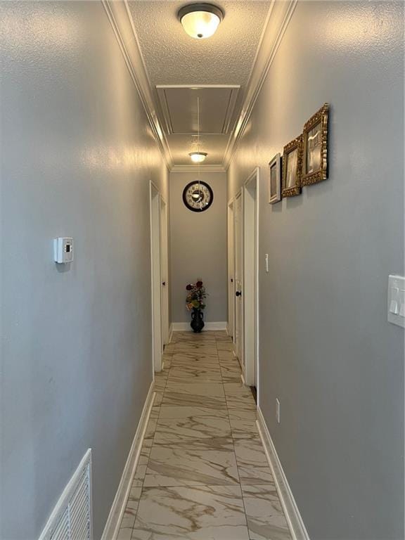 hall with crown molding and a textured ceiling