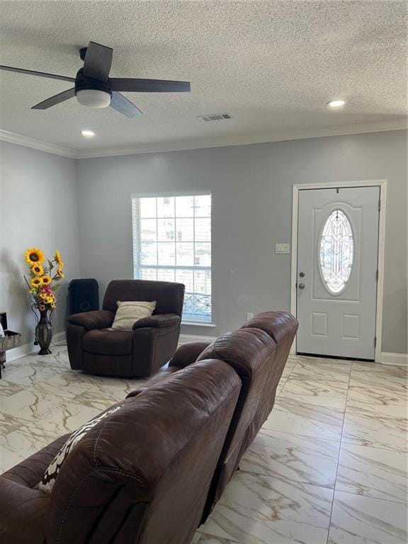 living room featuring a textured ceiling, ornamental molding, and ceiling fan