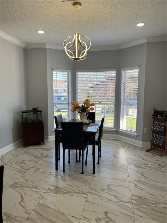 dining area featuring ornamental molding, a notable chandelier, and a textured ceiling