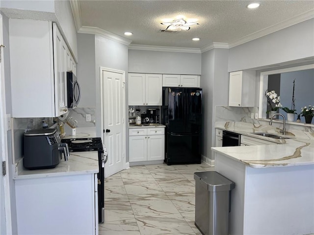 kitchen featuring sink, white cabinets, backsplash, and black appliances