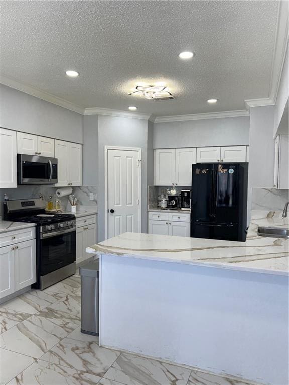 kitchen featuring sink, white cabinets, decorative backsplash, stainless steel appliances, and crown molding