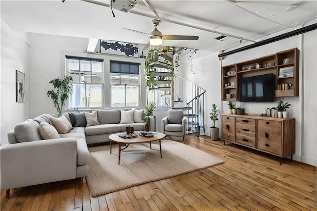 living room with light wood-type flooring and ceiling fan