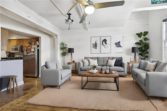 living room featuring hardwood / wood-style flooring and ceiling fan