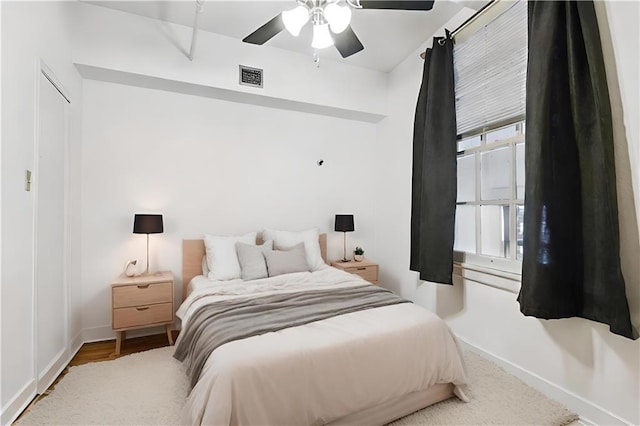 bedroom featuring multiple windows and ceiling fan