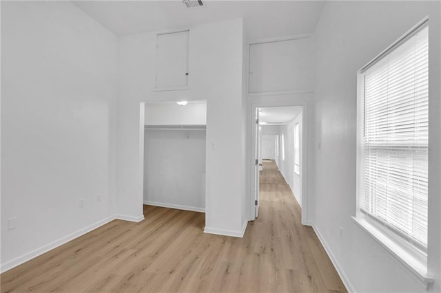 unfurnished bedroom featuring light hardwood / wood-style floors and a closet