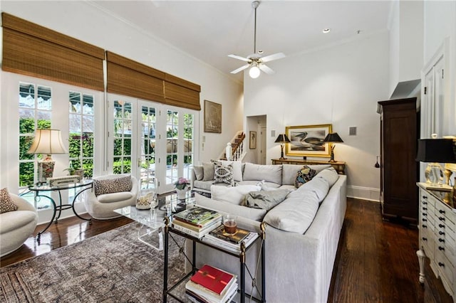 living room with french doors, a high ceiling, ceiling fan, dark wood-type flooring, and crown molding