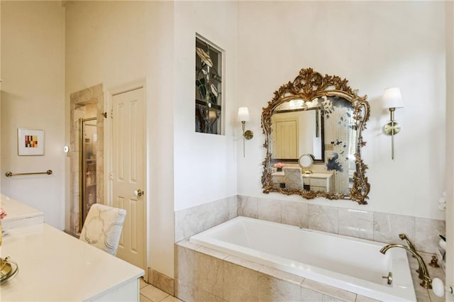 bathroom with plus walk in shower, vanity, and tile patterned floors