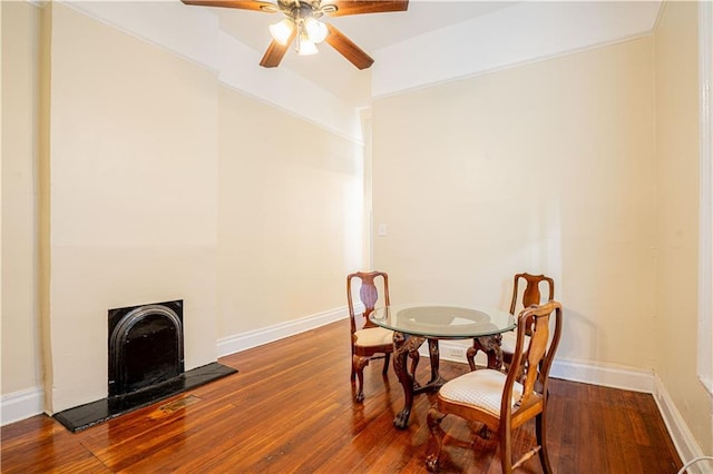 dining space with ceiling fan and wood-type flooring