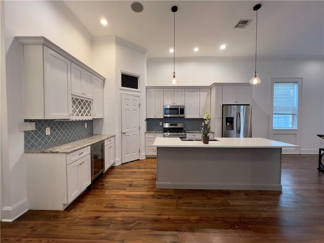 kitchen featuring wine cooler, hanging light fixtures, appliances with stainless steel finishes, and dark hardwood / wood-style floors