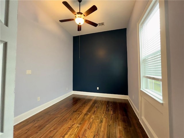 spare room featuring ceiling fan and dark hardwood / wood-style flooring