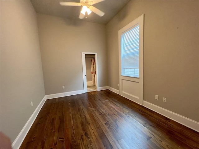 spare room featuring dark hardwood / wood-style flooring and ceiling fan