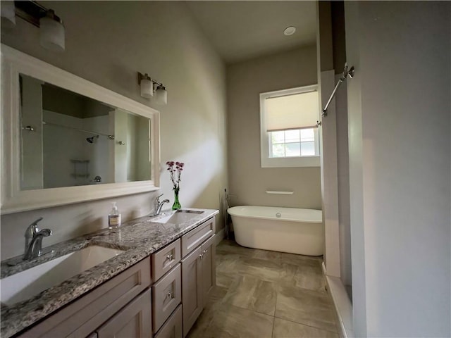 bathroom featuring vanity and a washtub