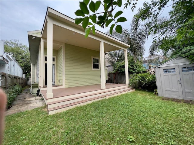 back of property with a shed, a deck, and a lawn