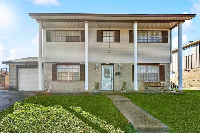 view of front of property with a front yard and a garage