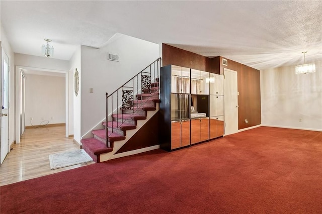 2027 Comet St, New Orleans, LA 70131 - living area with a chandelier, stairway, carpet, and a textured ceiling