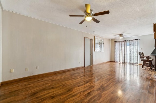 unfurnished living room featuring a textured ceiling, hardwood / wood-style flooring, and ceiling fan