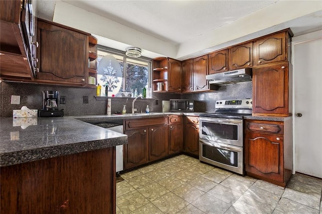 kitchen featuring appliances with stainless steel finishes, sink, tasteful backsplash, and dark brown cabinets