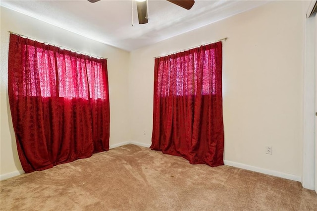 spare room with light colored carpet and ceiling fan