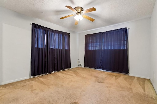 spare room with carpet floors, a textured ceiling, and ceiling fan