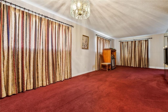 unfurnished room with a chandelier, carpet, and a textured ceiling