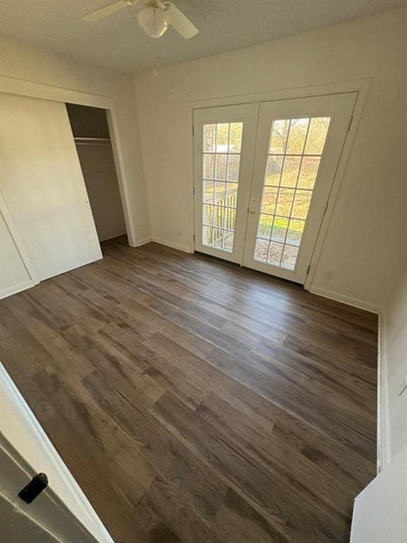 unfurnished bedroom with ceiling fan, access to outside, dark hardwood / wood-style floors, and a closet