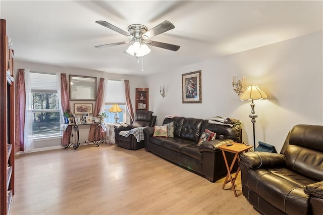 living room featuring ceiling fan and light hardwood / wood-style floors