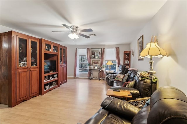 living room with light wood-type flooring and ceiling fan