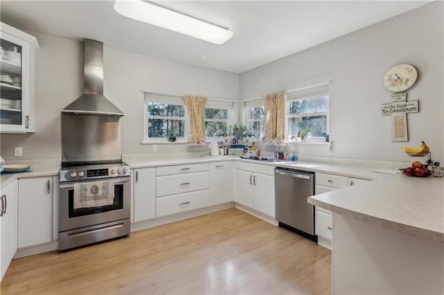 kitchen with white cabinets, stainless steel appliances, and extractor fan