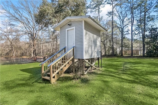 view of outbuilding with a lawn