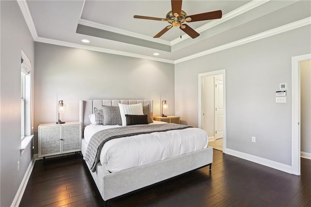 bedroom with a raised ceiling, ceiling fan, dark hardwood / wood-style floors, and ornamental molding