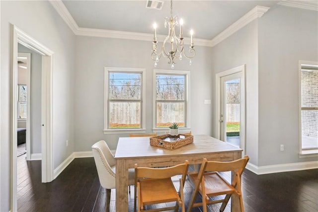 dining room with a notable chandelier, crown molding, and dark hardwood / wood-style floors