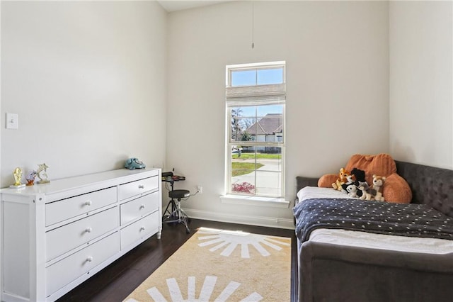 bedroom with dark hardwood / wood-style flooring