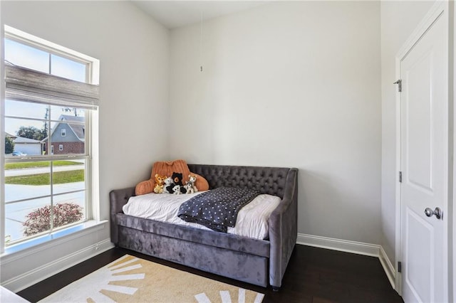 bedroom with dark hardwood / wood-style flooring