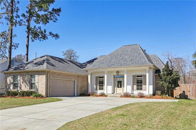 view of front of home featuring a garage, a front yard, and a porch