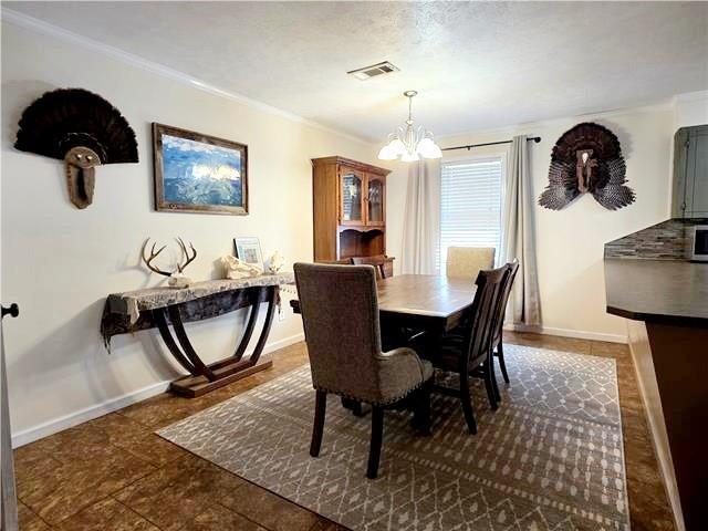 dining area with a notable chandelier and ornamental molding