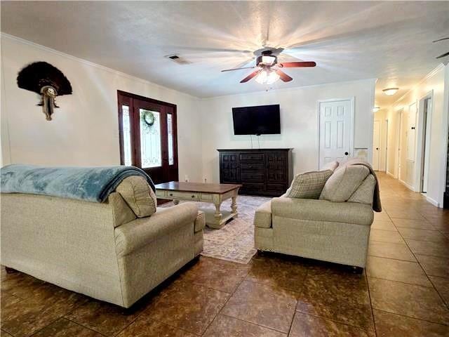 living room with ceiling fan and ornamental molding