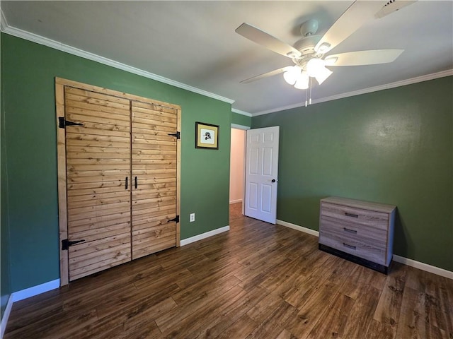 unfurnished bedroom featuring ceiling fan, crown molding, and dark hardwood / wood-style floors