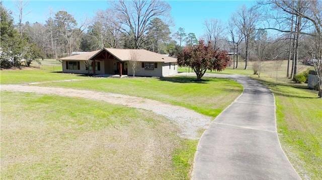 ranch-style home featuring a front yard