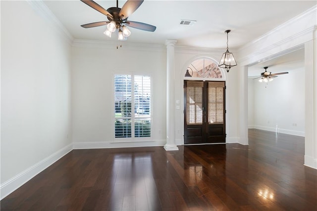 entrance foyer with crown molding, dark wood-type flooring, decorative columns, and ceiling fan