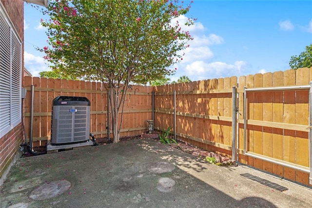 view of yard featuring cooling unit, a patio, and a fenced backyard