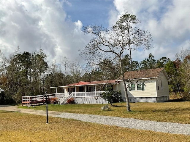 manufactured / mobile home with a porch and a front yard