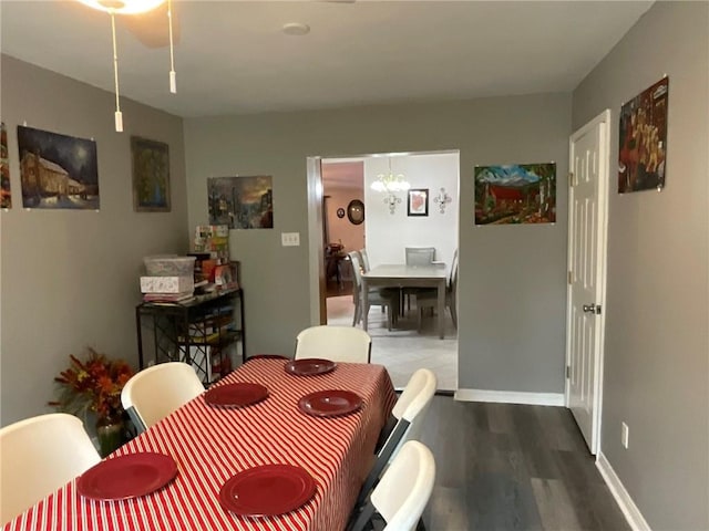 57428 Mainegra Rd, Slidell, LA 70460 - dining room with baseboards, wood finished floors, and a chandelier