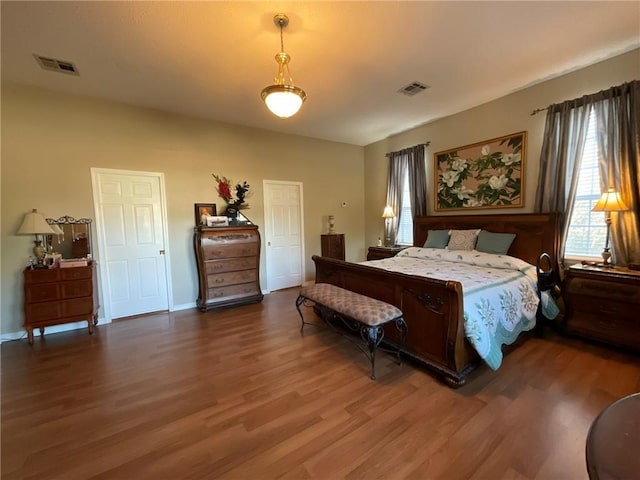 57428 Mainegra Rd, Slidell, LA 70460 - bedroom featuring baseboards, wood finished floors, and visible vents