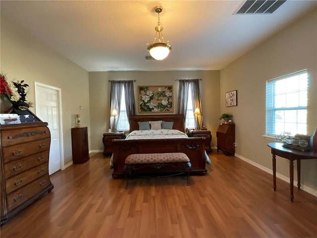 57428 Mainegra Rd, Slidell, LA 70460 - bedroom featuring baseboards, visible vents, and wood finished floors