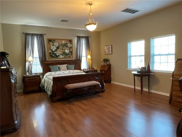 57428 Mainegra Rd, Slidell, LA 70460 - bedroom with visible vents, baseboards, and wood finished floors