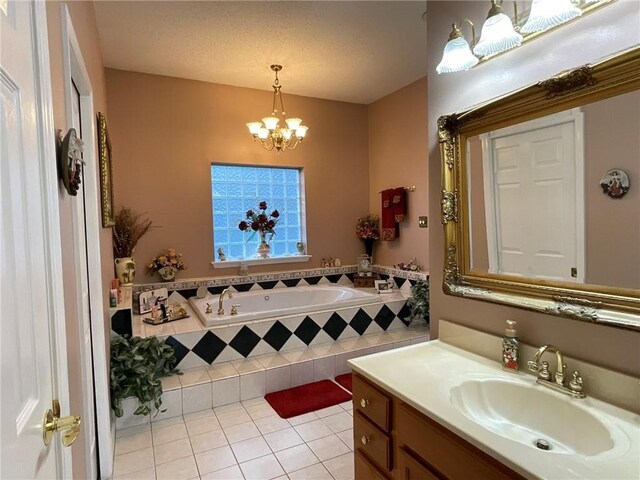 57428 Mainegra Rd, Slidell, LA 70460 - bathroom with tile patterned floors, an inviting chandelier, a garden tub, and vanity