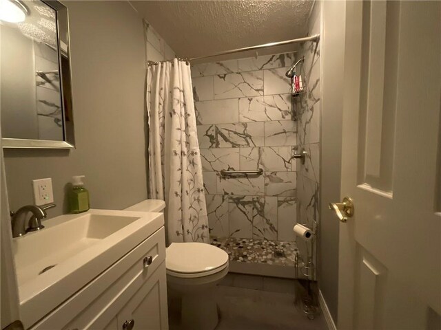 57428 Mainegra Rd, Slidell, LA 70460 - full bathroom with vanity, a textured ceiling, a stall shower, and toilet