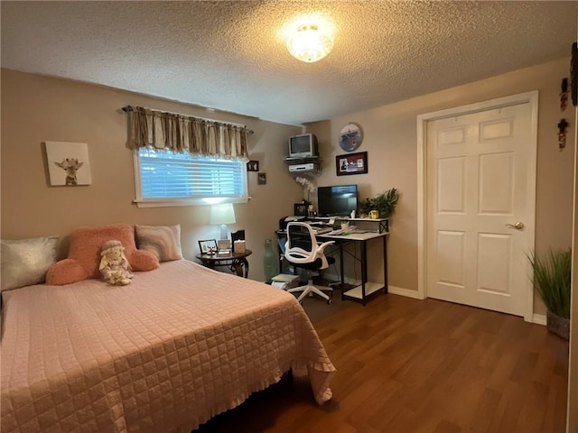 57428 Mainegra Rd, Slidell, LA 70460 - bedroom with a textured ceiling, baseboards, and dark wood-type flooring