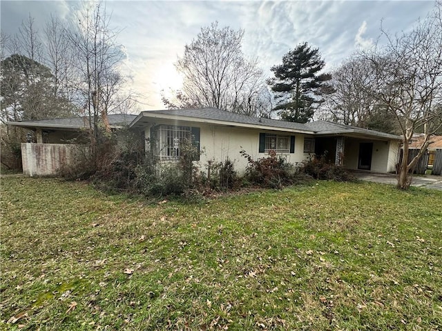 rear view of house featuring a yard